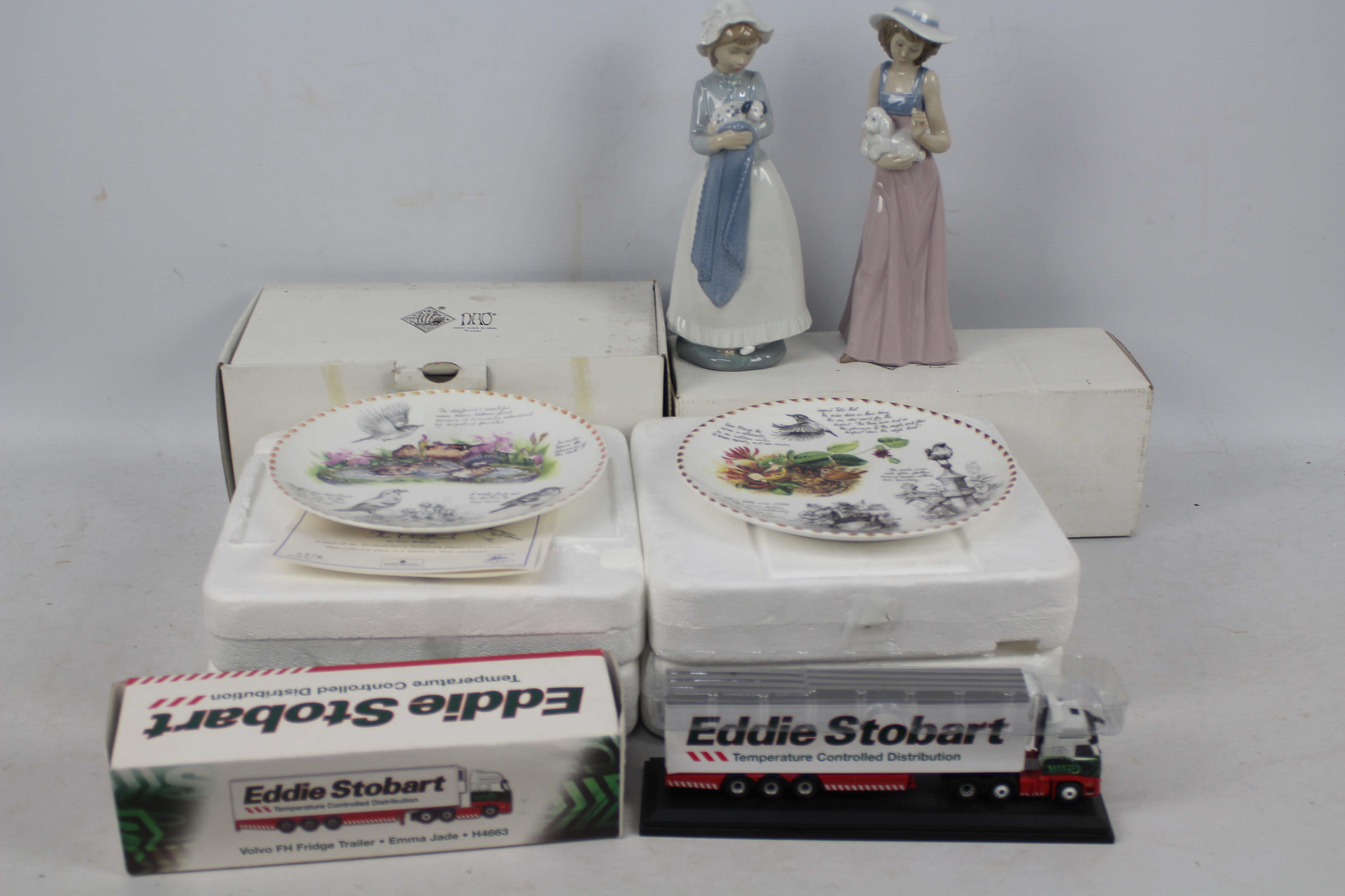 Two boxed Nao figures and four Wedgwood / Danbury Mint plates.