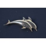 A 9ct yellow gold brooch in the form of two dolphins, 5.5 cm (l), approximately 8.4 grams.