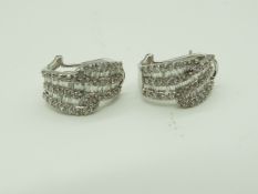 A lady's pair of white metal earrings stamped 18K (18 carat),