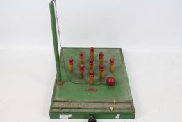 A vintage Amersham Games wooden table skittles game.