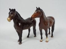 Two Beswick pony figures comprising Exmoor and New Forest, largest approximately 17 cm (h).