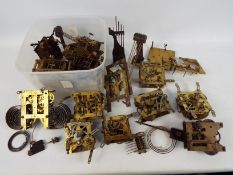 A collection of various clock movements and parts.