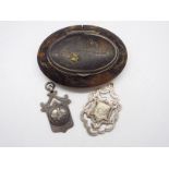 A Victorian tortoiseshell snuff box of oval form with white metal mounts and yellow metal inlay,