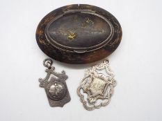 A Victorian tortoiseshell snuff box of oval form with white metal mounts and yellow metal inlay,