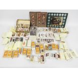 A collection of varied cigarette cards, largely organised into sets and a Historic Cars coin set.