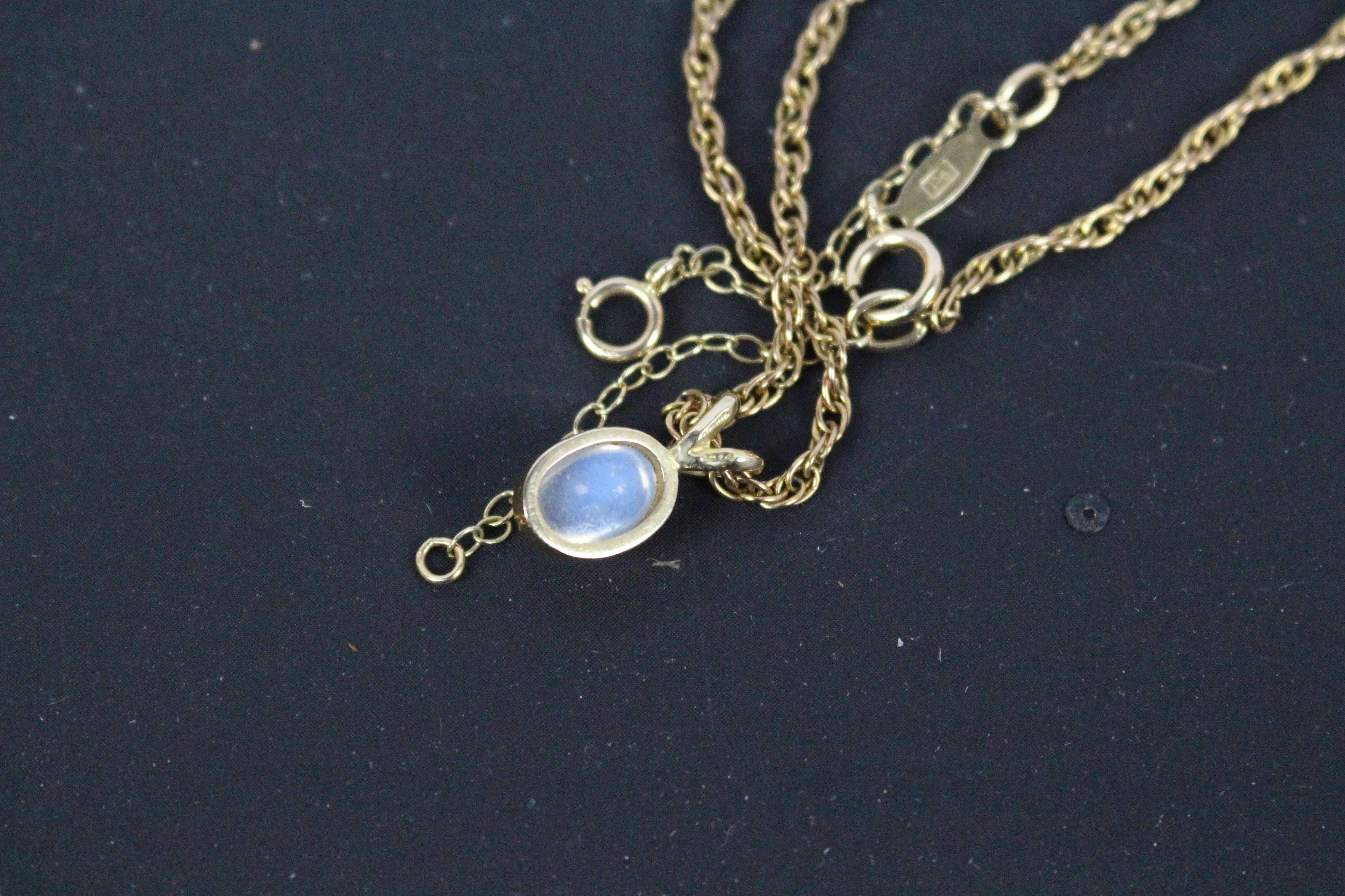 A 9ct yellow gold and cabochon moonstone pendant on 9ct gold Prince Of Wales chain (54 cm length), - Image 4 of 4