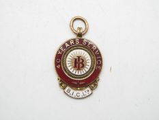 A 9ct rose gold and enamel 40 Years Service medal for B.I.C Ltd, approximately 8.1 grams.