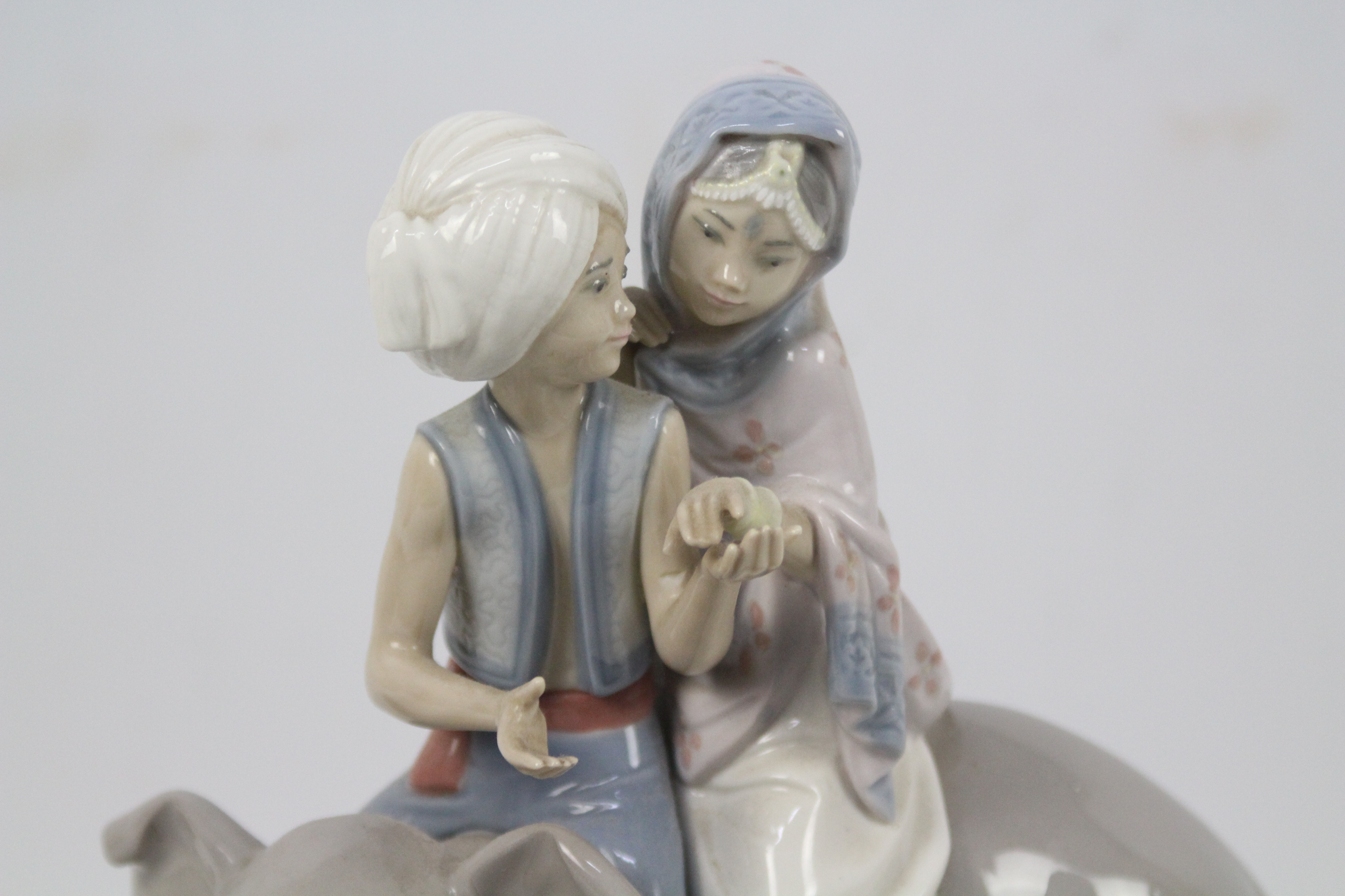 A Lladro figure group # 5352 Hindu Children, approximately 23 cm (h), with wooden display base. - Image 3 of 4