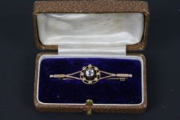 An aquamarine and seed pearl bar brooch in unmarked rose metal (presumed 9ct), 5.