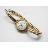 A lady's 9ct gold cased wrist watch on expanding bracelet marked 9ct Gold Metal Core,