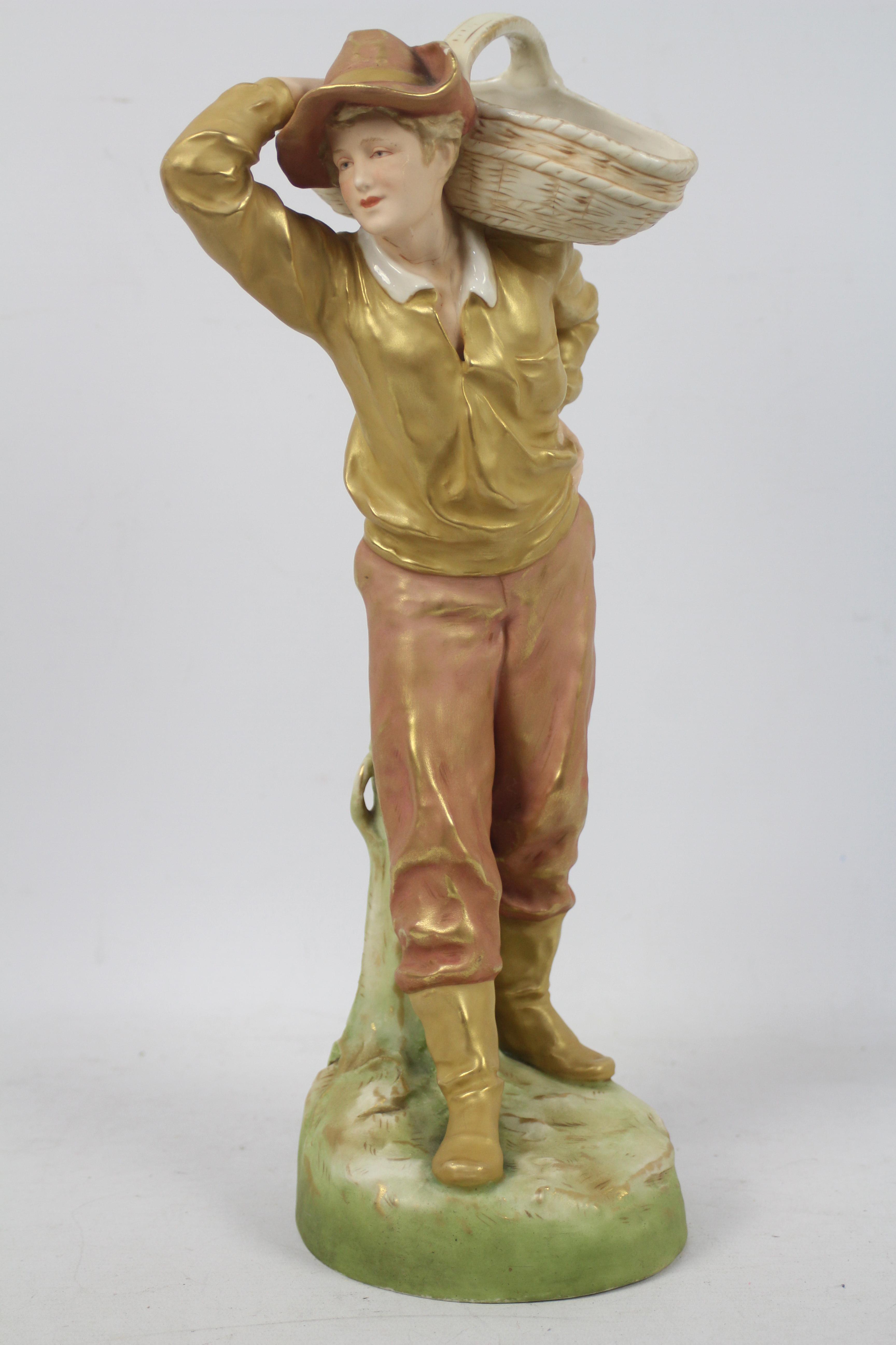 Royal Dux - A figure depicting a male carrying a basket on his shoulder,