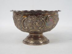 A late Victorian silver rose bowl decorated with repousse floral scrolls, London assay 1900,