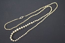 A necklace of graduated pearls with sapphire and diamond set clasp stamped 9ct, 60 cm (l).