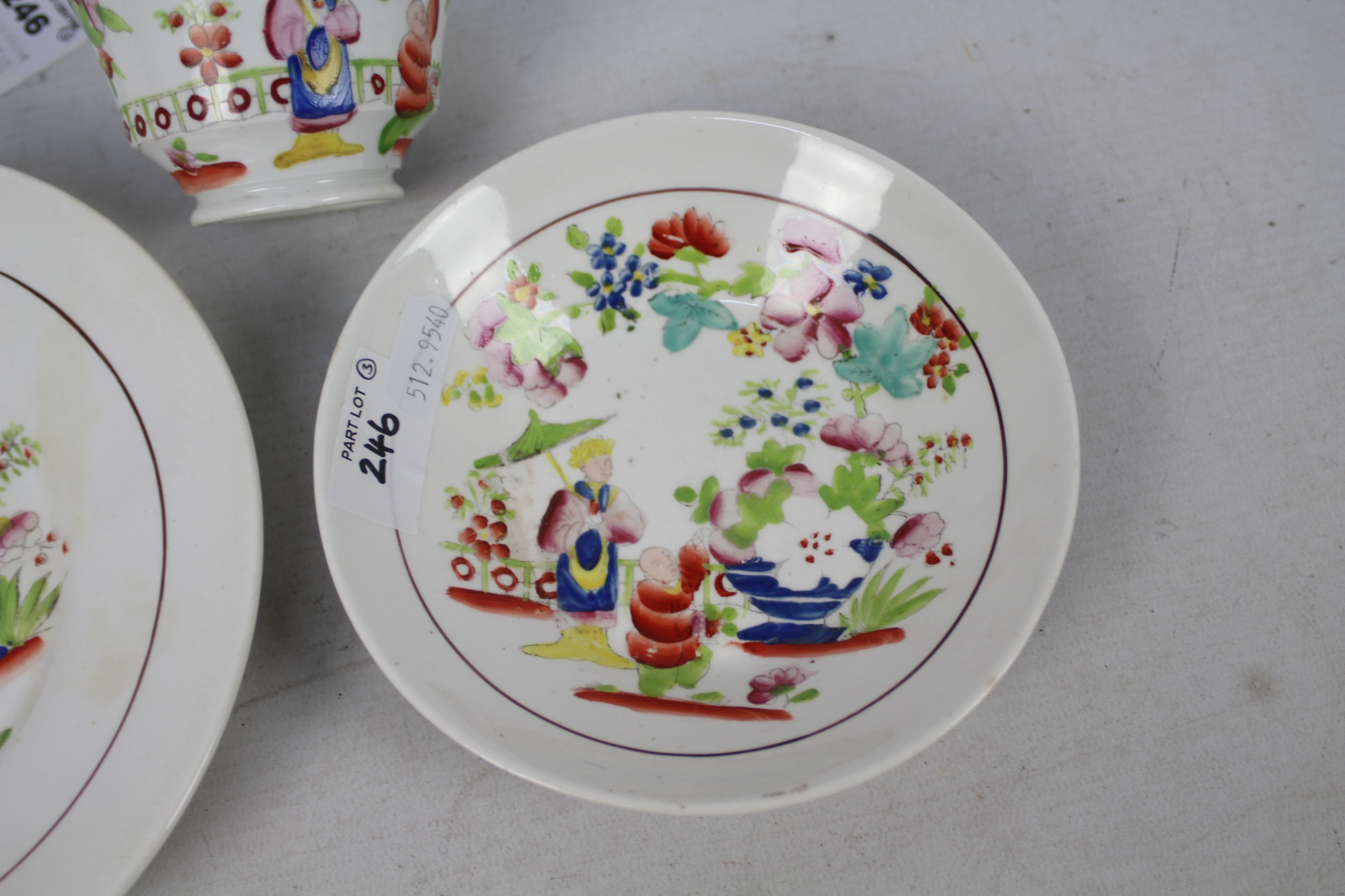 A cup, saucer and plate decorated with figures in a garden setting, unmarked to the base, - Image 3 of 6