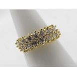 An 18ct yellow gold ring set with two rows of round brilliant cut white stones, size M+½,