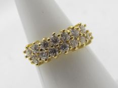 An 18ct yellow gold ring set with two rows of round brilliant cut white stones, size M+½,