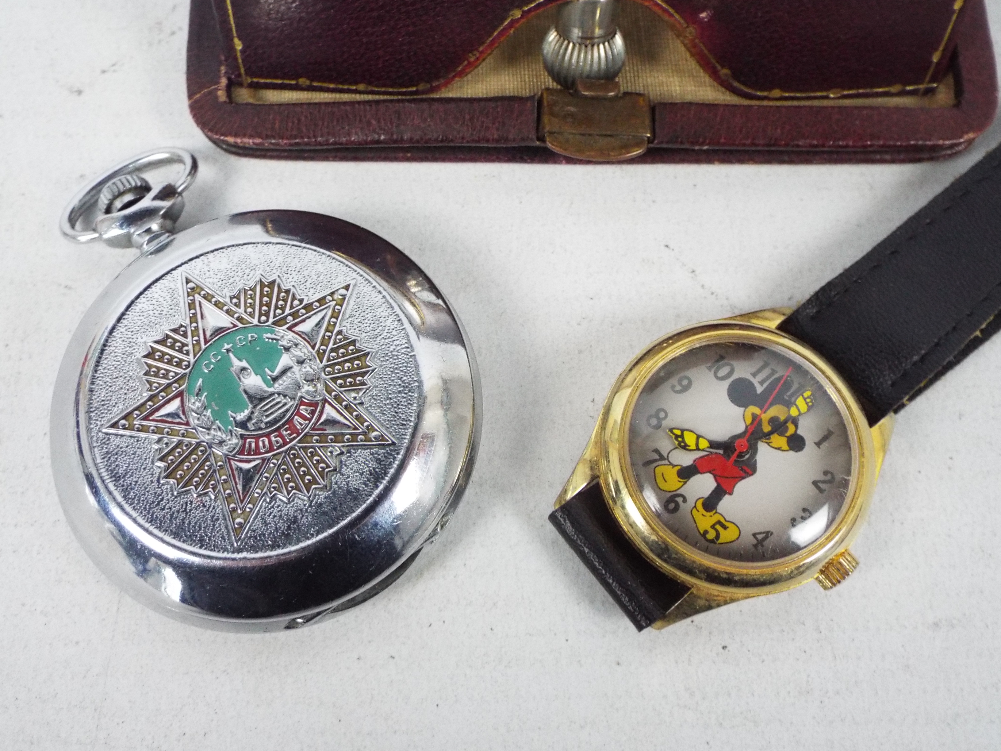 A vintage German travel clock in leather pouch, Russian pocket watch and a wrist watch. - Image 2 of 8