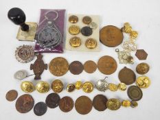 Lot to include buttons, cap badges, German Third Reich style desk stamp, medallions,