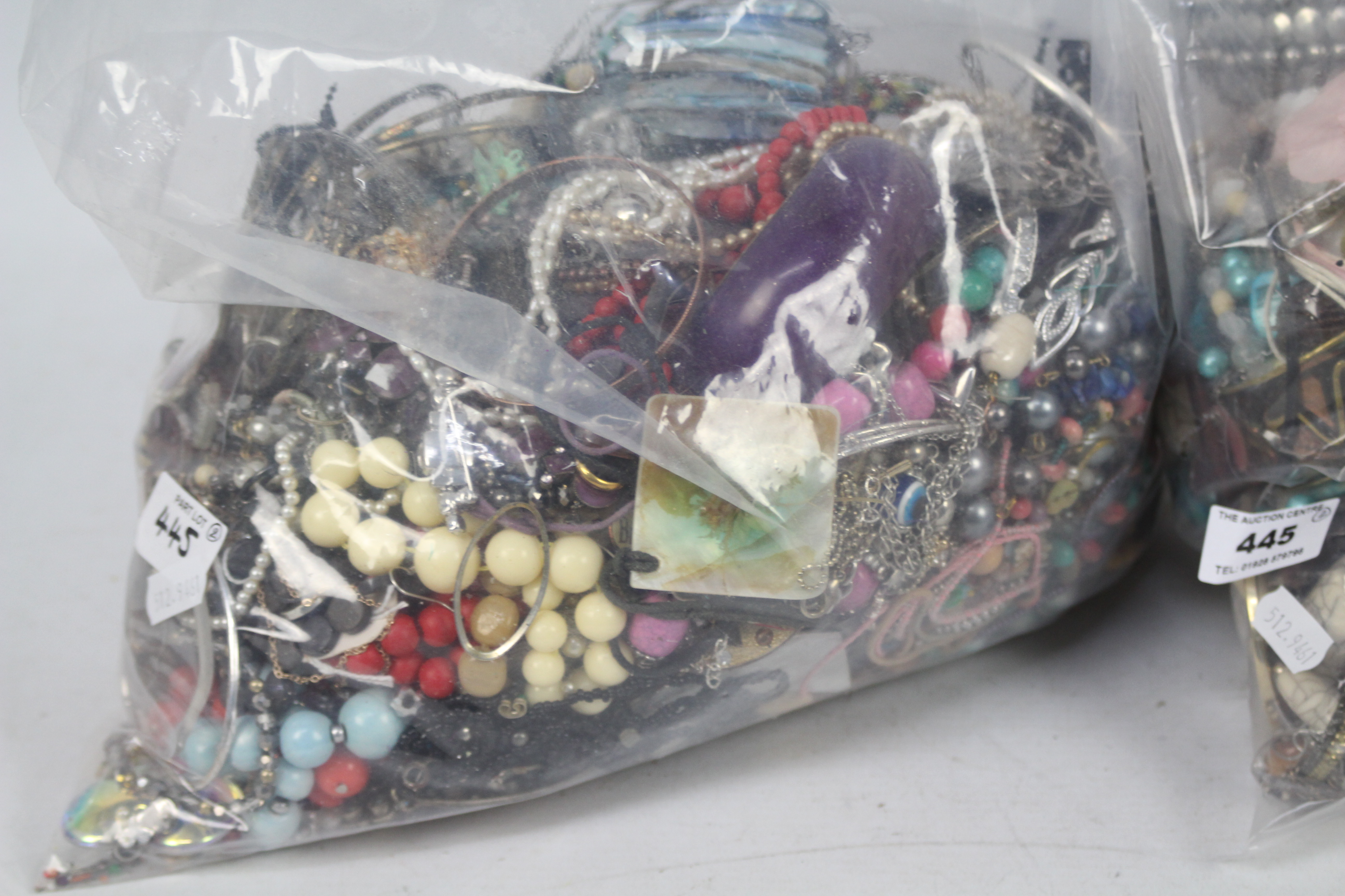 Two clear bags of unsorted costume jewellery, in excess of 10 kg. - Image 2 of 3