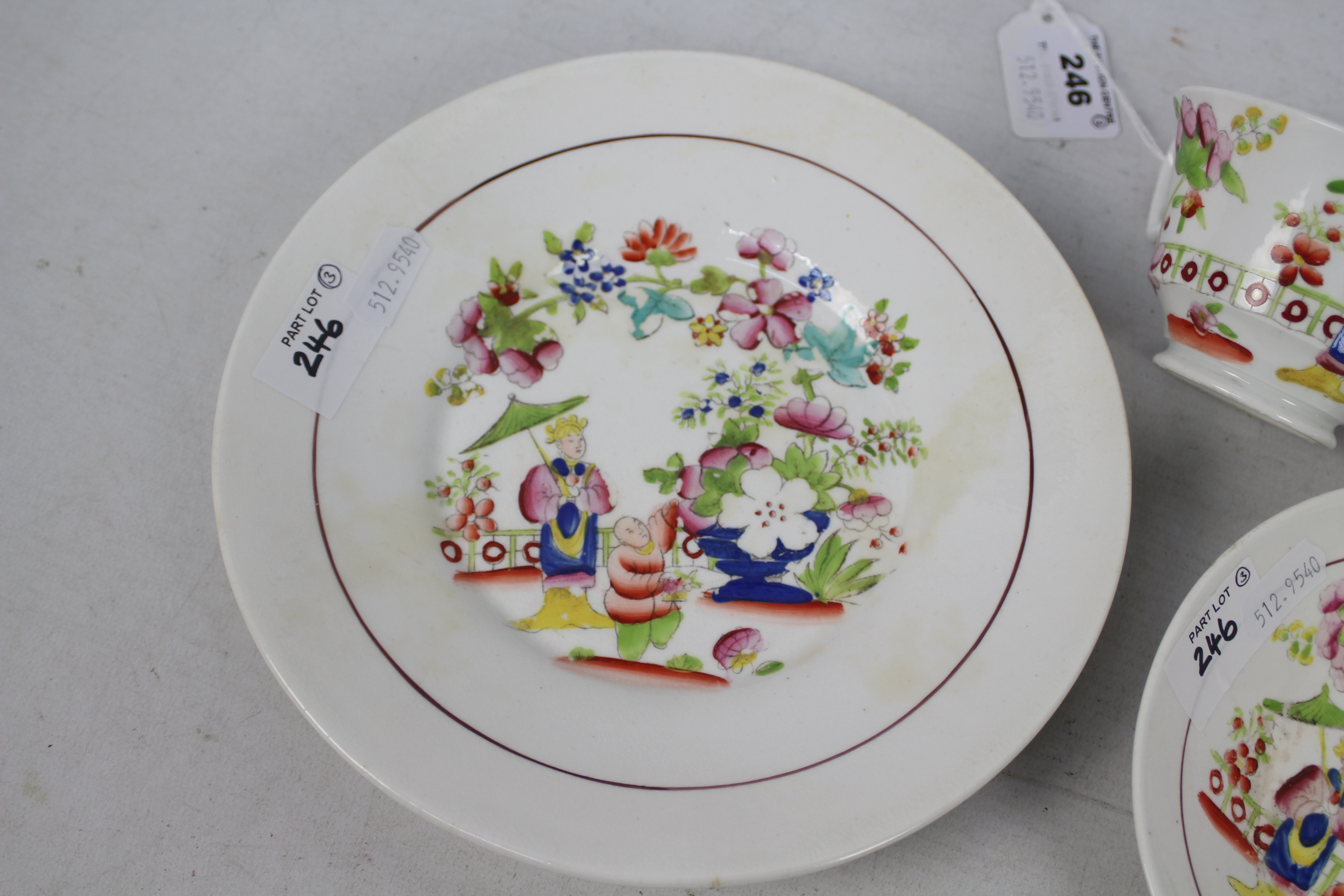 A cup, saucer and plate decorated with figures in a garden setting, unmarked to the base, - Image 2 of 6