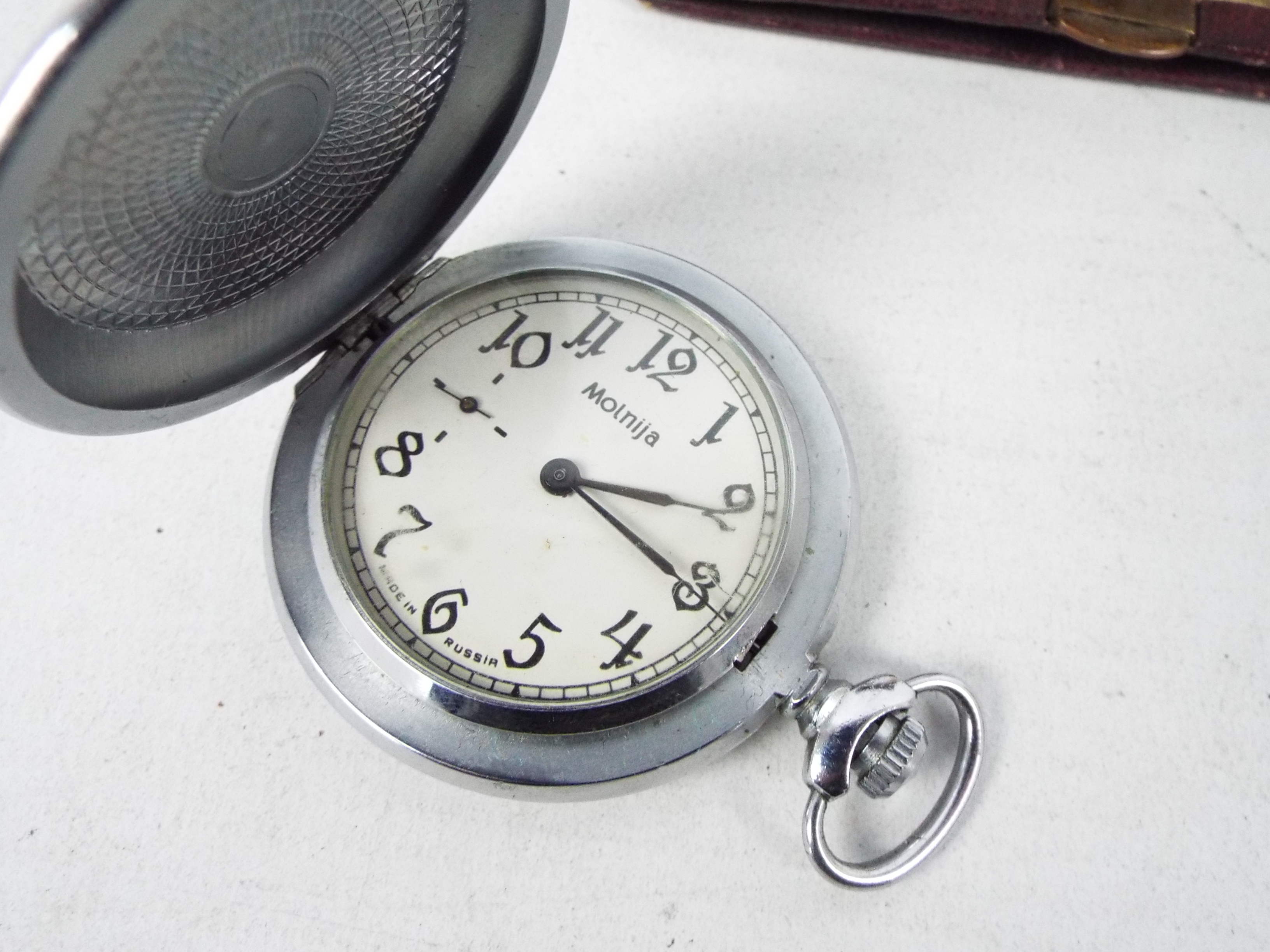 A vintage German travel clock in leather pouch, Russian pocket watch and a wrist watch. - Image 6 of 8