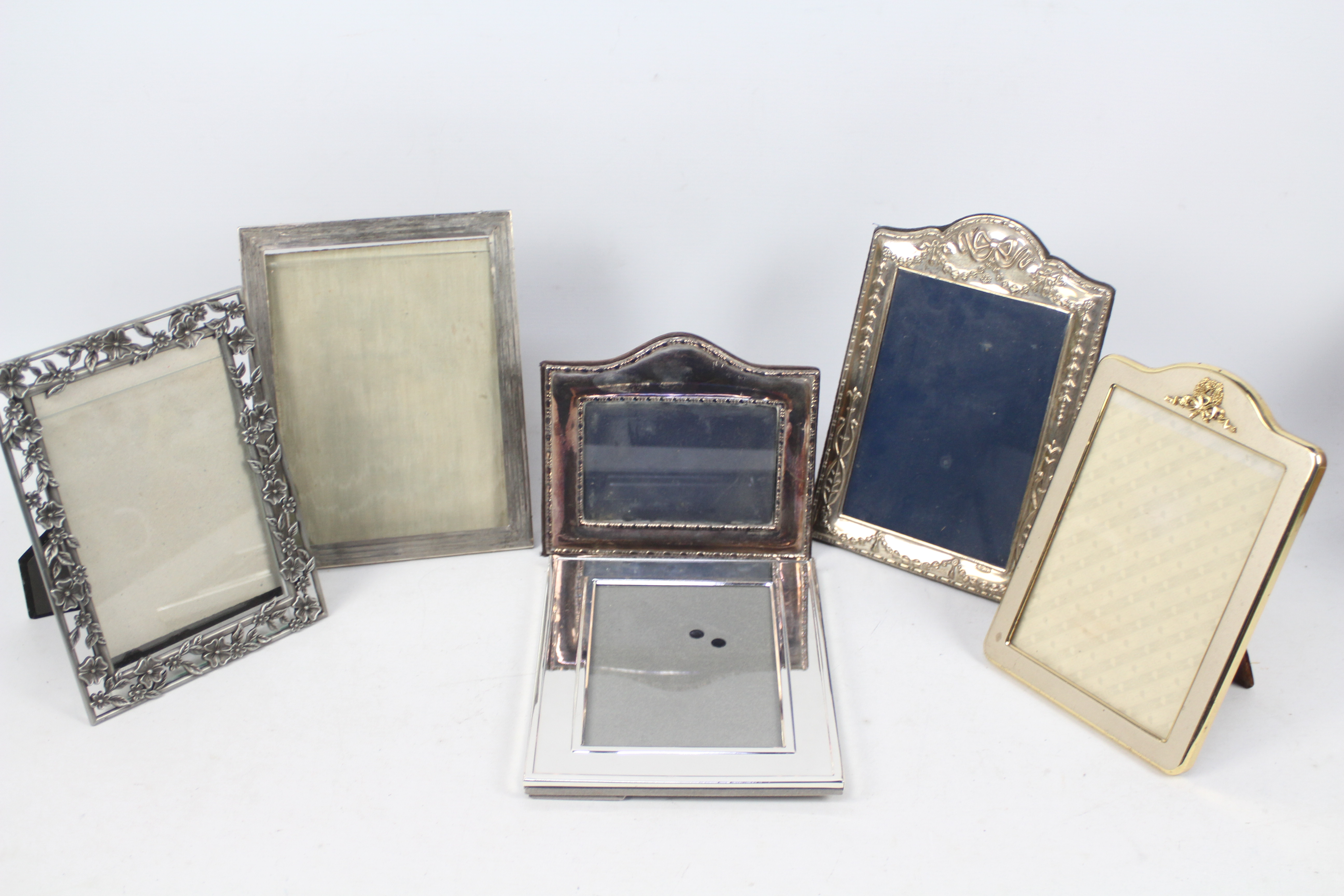 Six easel back photograph frames three of which are silver mounted,