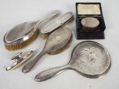 A collection of silver mounted dressing table items,