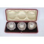 Three Victorian silver pierced silver dishes contained in fitted case, Birmingham assay,