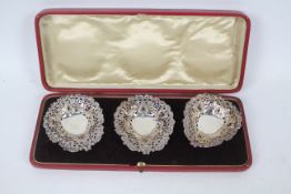 Three Victorian silver pierced silver dishes contained in fitted case, Birmingham assay,