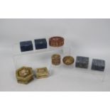 A collection of carved stone trinket boxes, largest approximately 3.5 cm x 7.5 cm.