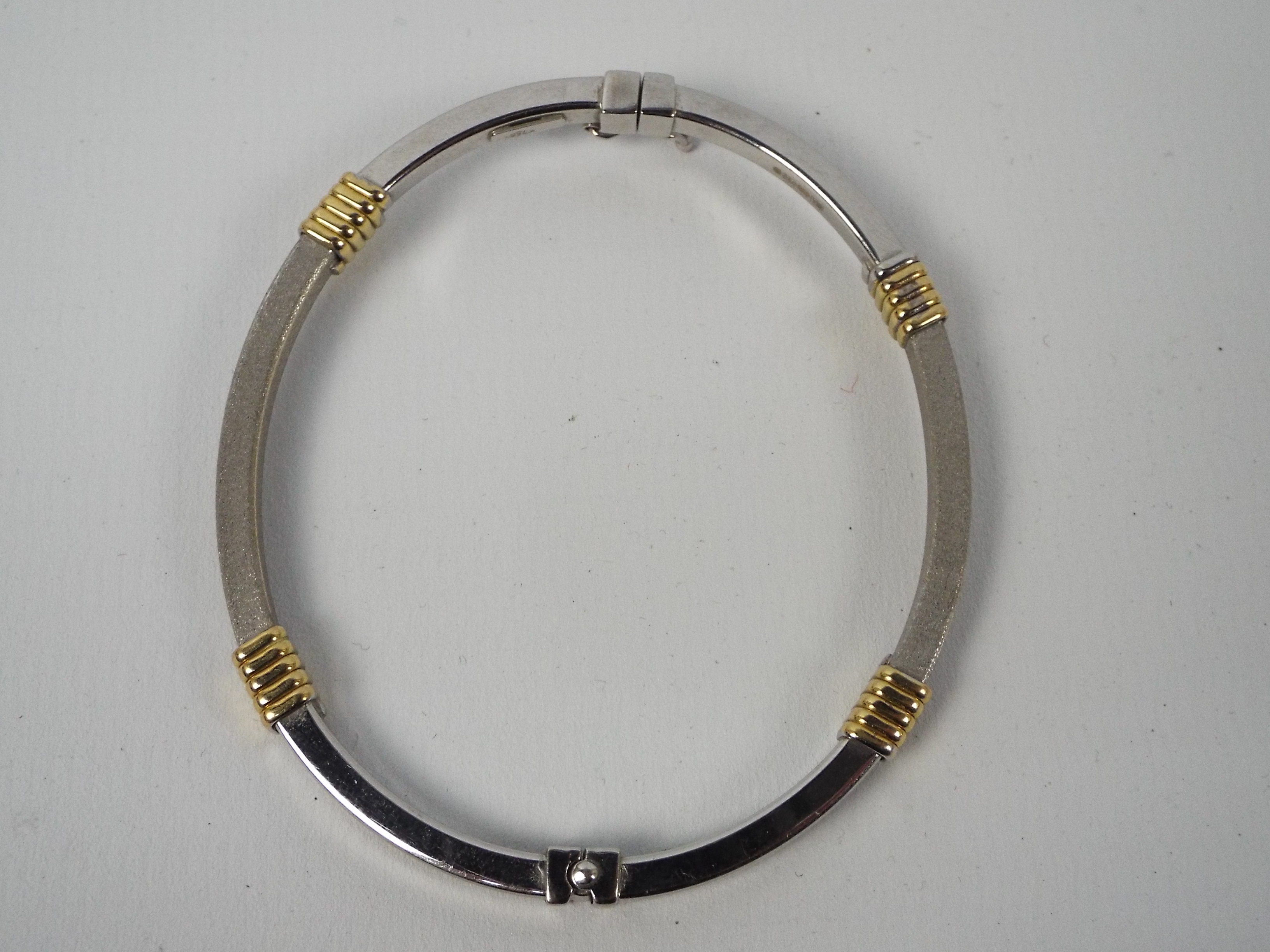 An 18ct gold two-tone hinged bangle with safety clasp, 5. - Image 2 of 2