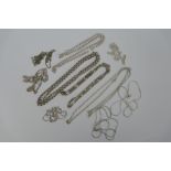 A collection of ten silver and white metal necklaces, various lengths.