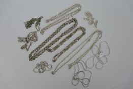 A collection of ten silver and white metal necklaces, various lengths.