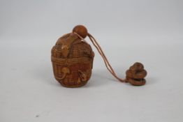 A single case carved wood inro in the form of a basket with mice and a snake,