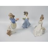 Three Nao figures of young girls with animals, largest approximately 19 cm (h).