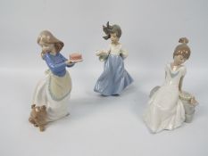 Three Nao figures of young girls with animals, largest approximately 19 cm (h).
