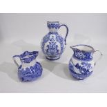 Three blue and white jugs / ewers of graduated size comprising a Gien faience example decorated in