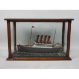 A scratch built model ship in glazed display depicting RMS Mauretania,