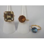 Three lady's yellow metal (presumed 9 ct) dress rings set with a synthetic stones, approx weight 15.
