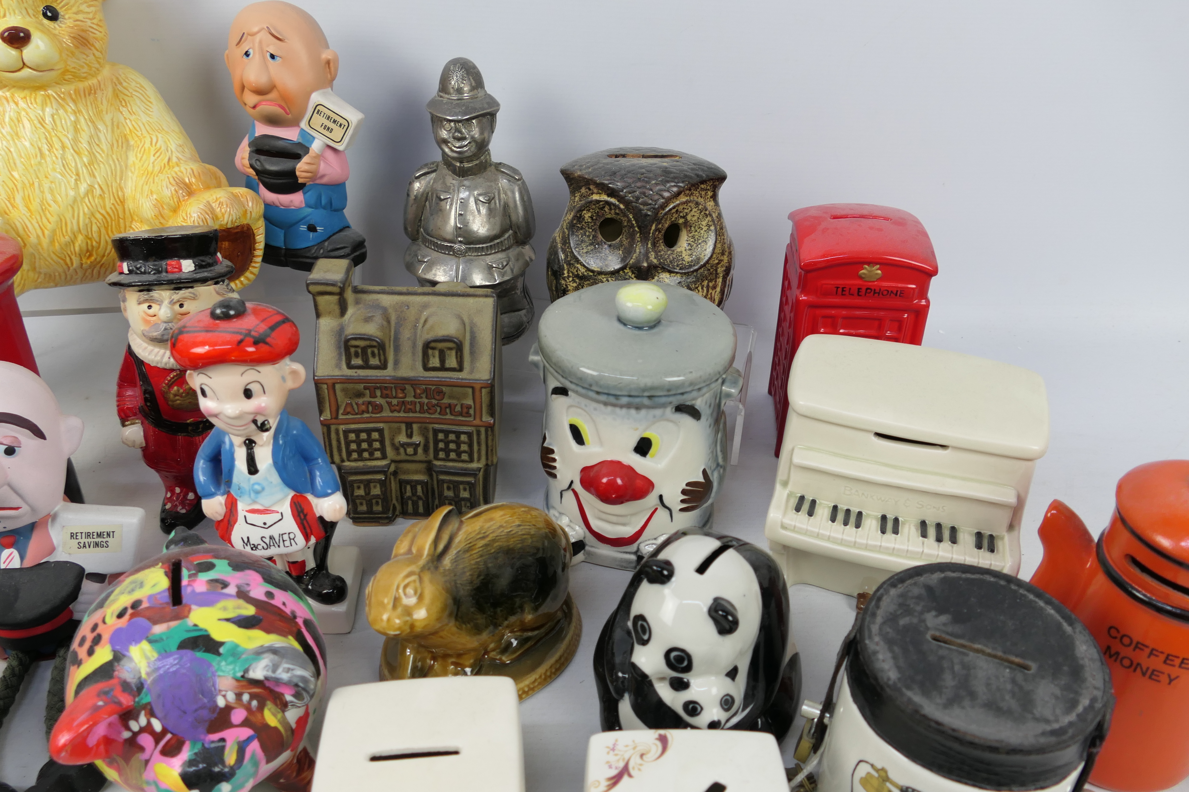 A collection of various money banks, predominantly ceramic. - Image 5 of 5