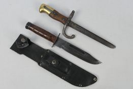 A USMC Mark 2 style combat knife with associated sheath and a trench knife formed from a cut down