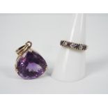 A 9ct yellow gold ring set with cz and amethyst, size O+½ and a 9ct and amethyst pendant,