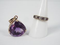 A 9ct yellow gold ring set with cz and amethyst, size O+½ and a 9ct and amethyst pendant,