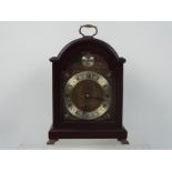 A Garrard mahogany cased mantel clock with Roman numerals to a silvered chapter ring and Tempus