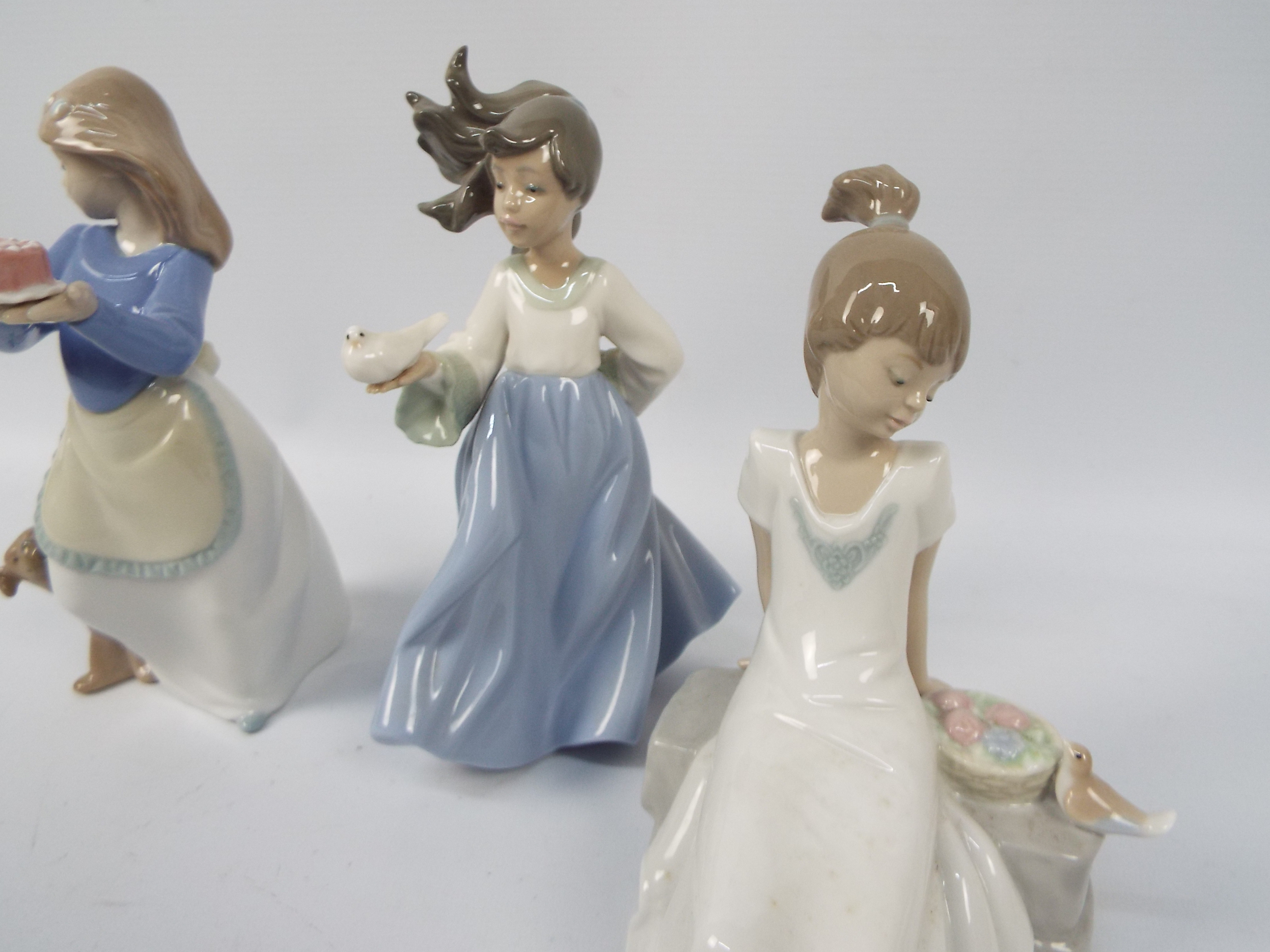 Three Nao figures of young girls with animals, largest approximately 19 cm (h). - Image 4 of 4