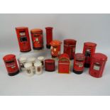 A group of vintage money banks in the form of Post Office pillar boxes comprising crested ware