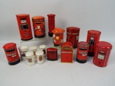 A group of vintage money banks in the form of Post Office pillar boxes comprising crested ware