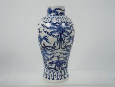 A blue and white vase with scrolled floral decoration, four character Kangxi mark to the base,
