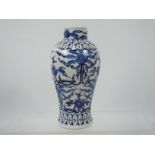 A blue and white vase with scrolled floral decoration, four character Kangxi mark to the base,