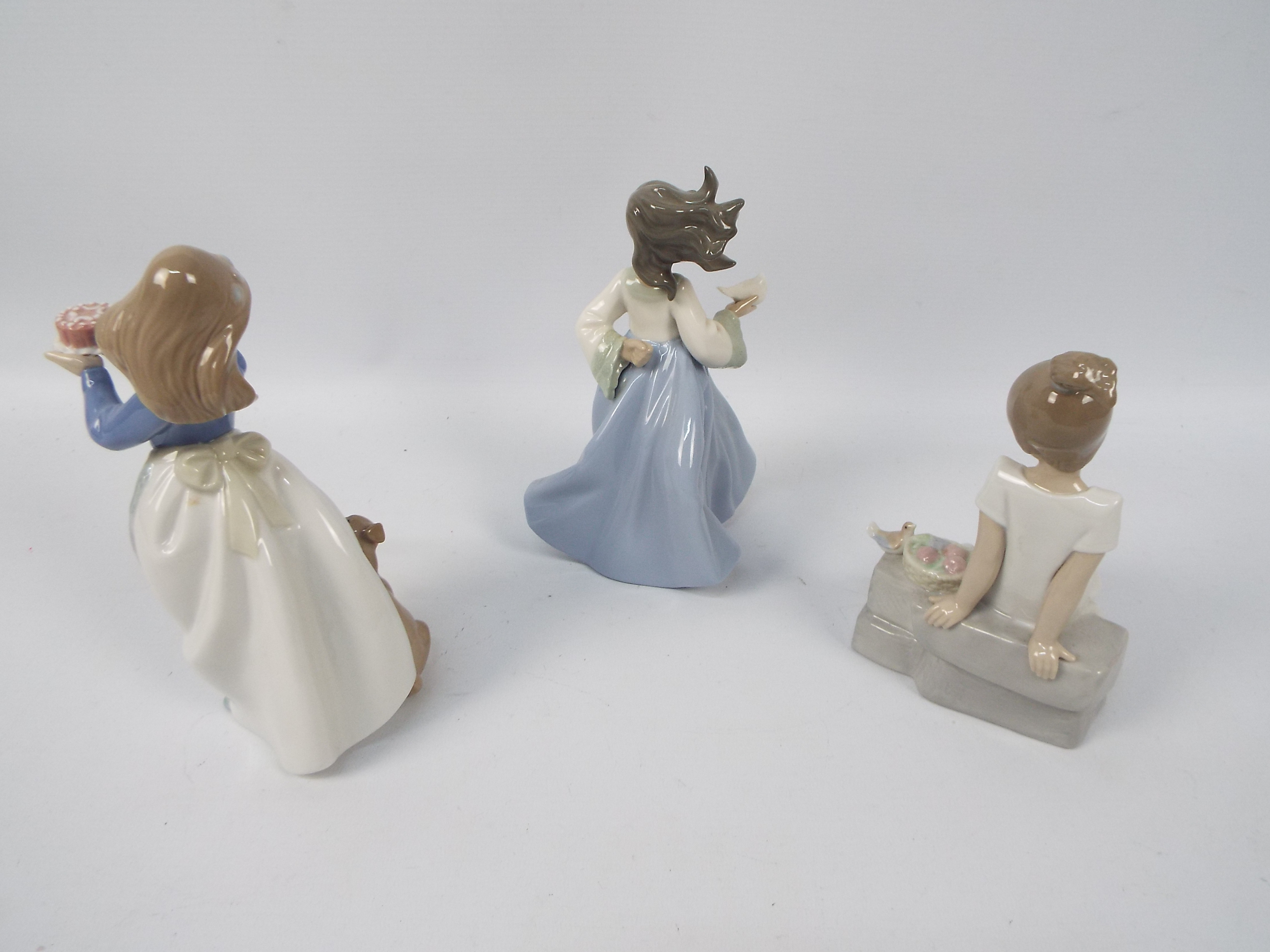 Three Nao figures of young girls with animals, largest approximately 19 cm (h). - Image 2 of 4
